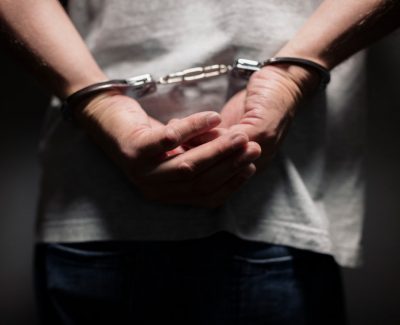 man wearing handcuffs before getting criminal defense lawyers help seguin tx